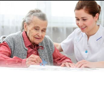 elderly woman in a wheelchair with her caregiver